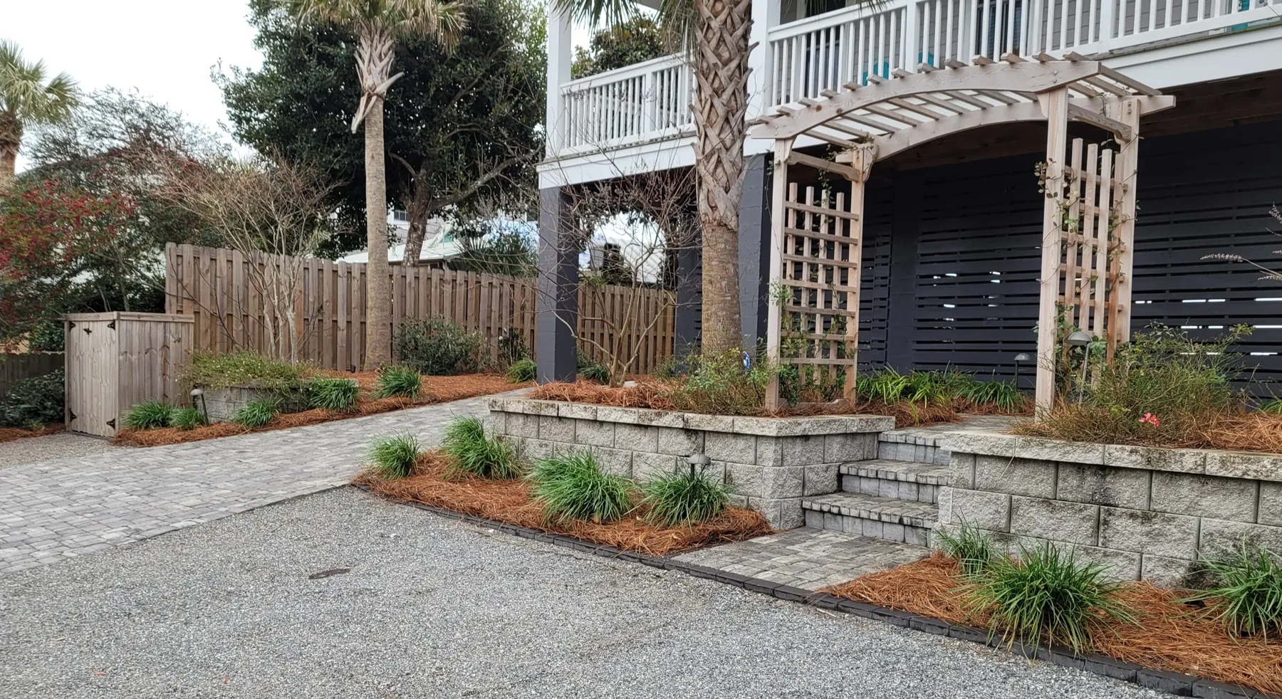 Driveway and planting bed installation beneath a raised Lowcountry home