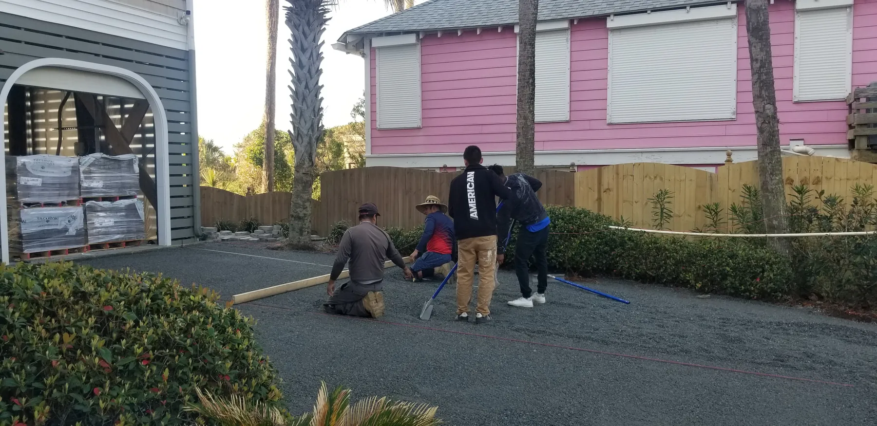 Priority Landscaping crew installing plantings and hardscape at a Folly Beach cottage